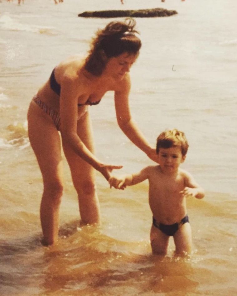 James as a small boy, held by the hand in the sea